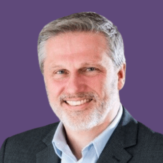 Profile picture of Jason Colyer, smiling at camera wearing a grey suit.