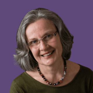 Profile picture of Gilda Westermann, smiling at camera, wearing green top and bead necklace.