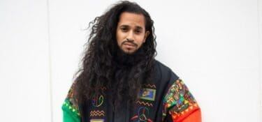 Profile photo of Bilal Harry Khan, looking at camera and wearing a colourful jacket