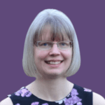 Profile picture of Anna Whitehead, smiling at camera and wearing a floral print top.