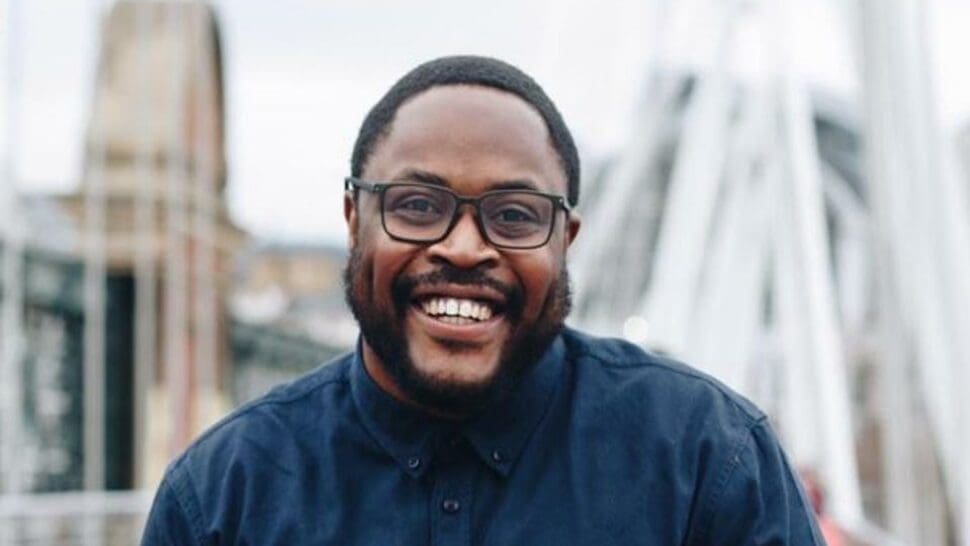 Profile Photo of Tumi Sotire Wearing blue shirt and smiling