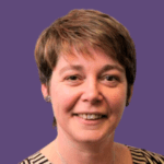 Profile photo of Anita Hayne, smiling at camera, wearing a patterned top.