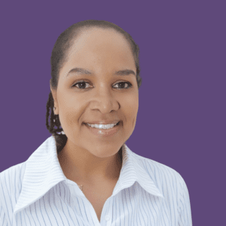 Profile picture of Nicole Etienne, smiling at camera, wearing a striped white shirt.