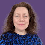 Profile pictire of Briony Craig, smiling at camera, wearing a blue patterned top