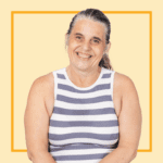 Light yellow background with image of Helen Charnock, wearing a black and white striped vest, smiling at the camera.