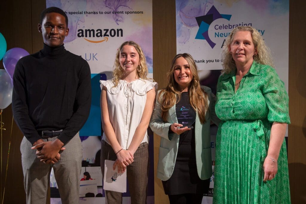The team from Smithdown Primary School, holding their award smiling at the camera alongside the CND Award host, Kirsty Campbell and the category sponsor representative.