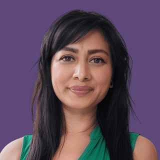 Image of Runa Begum smiling at the camera, wearing a green blouse