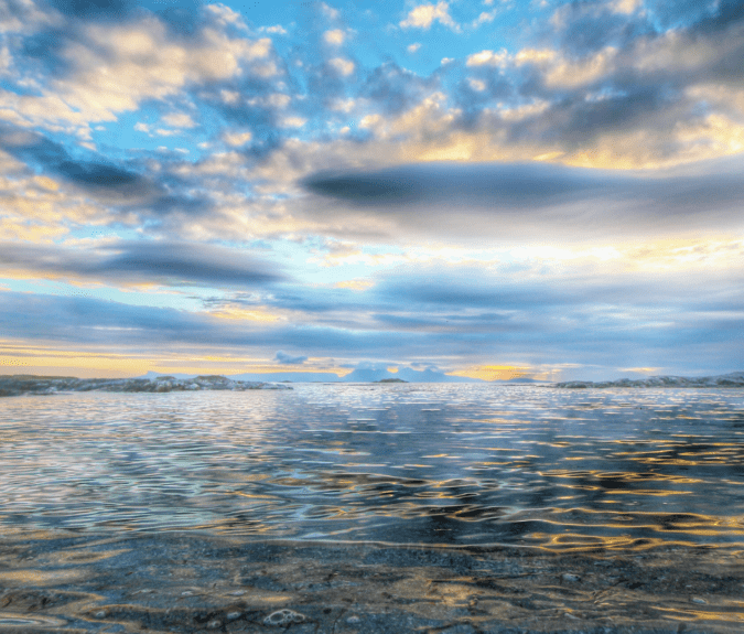 Image of the calm sea on a sunny, cloudy day