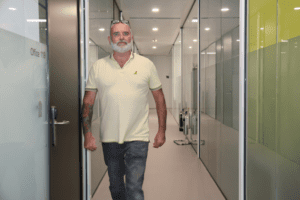 Man walking down corridor of office