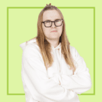 Light green background with image of Joe Dugdale wearing a white hoodie and glasses, smiling at the camera