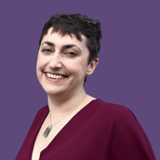 Purple background with image of Gemma Drinkall wearing a red blouse and smiling at the camera.