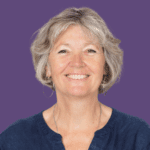 Purple background with image of Nancy Proctor smiling at the camera