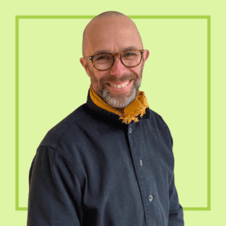 Light green background with image of Simon Falconer smiling at the camera.